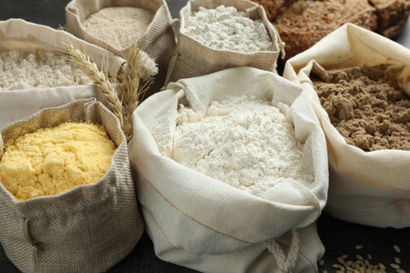 Different types of flour in bags on grey table, closeupの写真素材