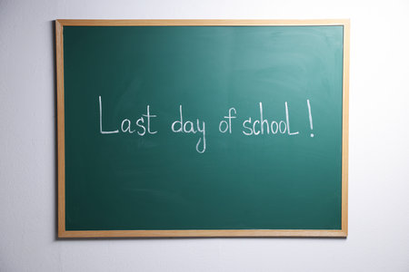 Phrase Last Day of School with exclamation mark on blackboardの写真素材