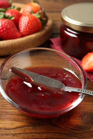 Delicious strawberry sauce and fresh berries on wooden table, closeupの写真素材