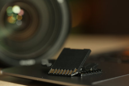 SD memory cards, laptop and photo camera on table, closeupの写真素材