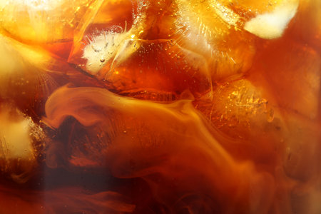 Refreshing coffee with ice and milk as background, closeupの写真素材