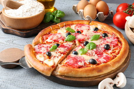 Tasty pizza and ingredients on grey wooden table, closeupの写真素材