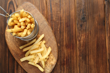 Tasty french fried served on wooden table, top view. Space for textの写真素材