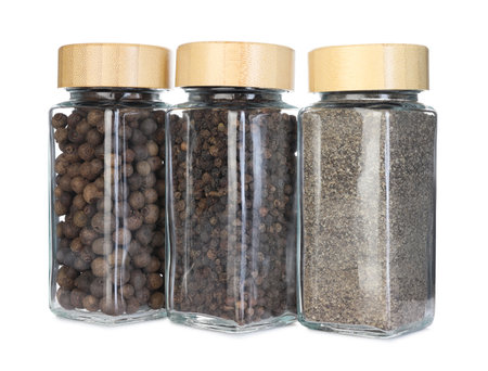 Many different aromatic spices in jars isolated on whiteの写真素材