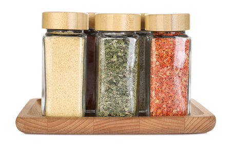 Many different aromatic spices in jars isolated on whiteの写真素材