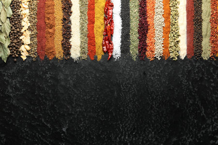 Many different spices on black table, flat lay. Space for textの写真素材