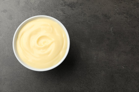 Tasty vanilla pudding on black table, top view. Space for textの写真素材