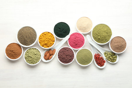 Different superfood powders on white wooden table, flat layの写真素材