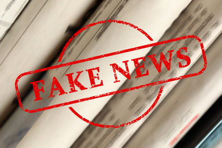 Red News stamp and newspapers as background, closeupの写真素材