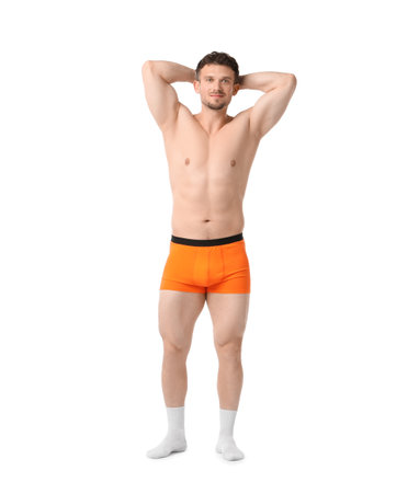 Young man in orange underwear on white backgroundの写真素材