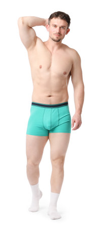 Young man in stylish turquoise underwear on white backgroundの写真素材