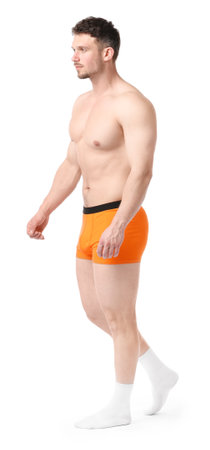 Young man in orange underwear on white backgroundの写真素材
