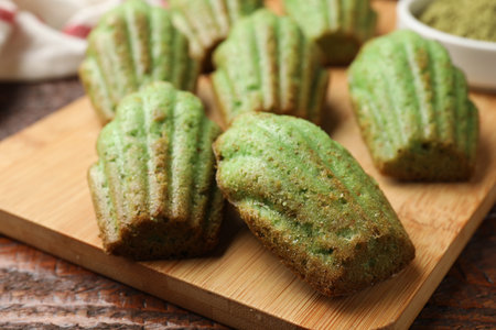 Tasty matcha madeleine cakes on wooden table, closeupの写真素材