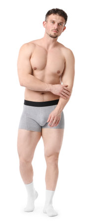 Young man in light grey underwear on white backgroundの写真素材