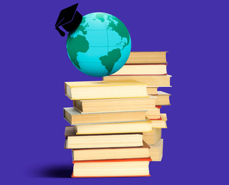Graduate cap illustration and globe over books on blue backgroundの写真素材