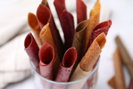 Tasty fruit leather rolls on white background, closeupの写真素材