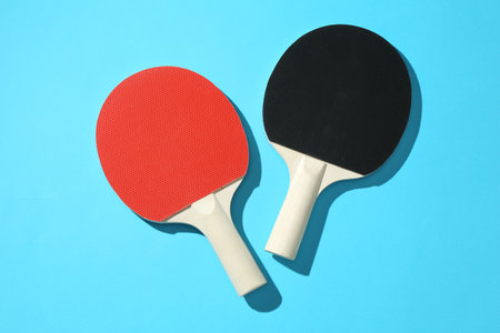Ping pong rackets on blue background, top viewの写真素材