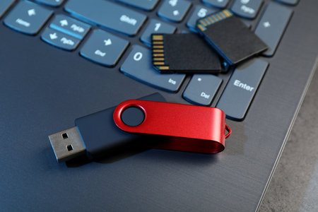 SD memory cards, USB flash drive and laptop on dark grey table, closeupの写真素材