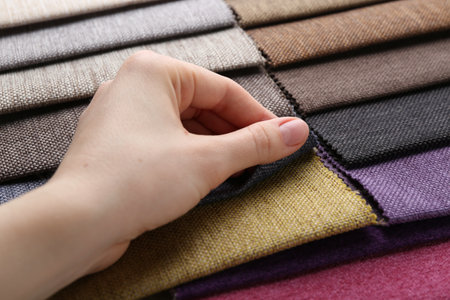 Woman with samples of different fabrics, closeupの写真素材