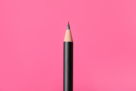 Sharp graphite pencil on pink background, closeupの写真素材