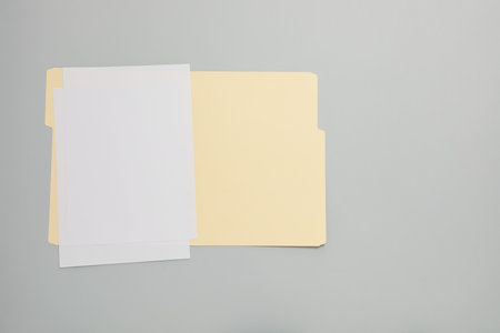 Paper file folder with blank sheets on gray background, top view. Space for textの写真素材