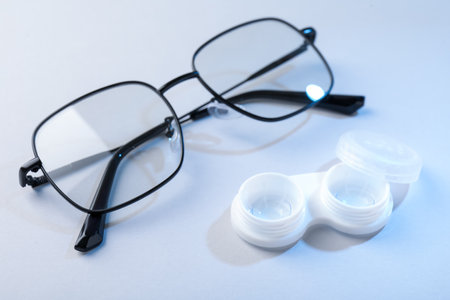 Case with contact lenses and glasses on white background, closeupの写真素材