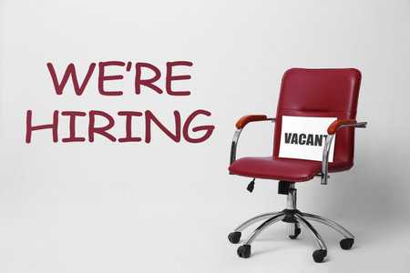 Office chair with Vacant sign on light background.の写真素材