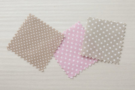 Samples of different fabrics on white wooden table, flat lay