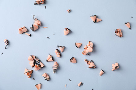 Shavings of graphite pencils on light grey background, flat layの写真素材