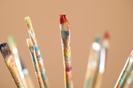 Paintbrushes on light brown background, closeupの写真素材