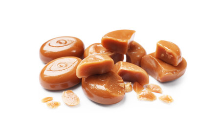 Broken tasty caramel candies isolated on whiteの写真素材