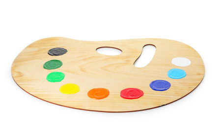 Wooden palette with paints isolated on whiteの写真素材
