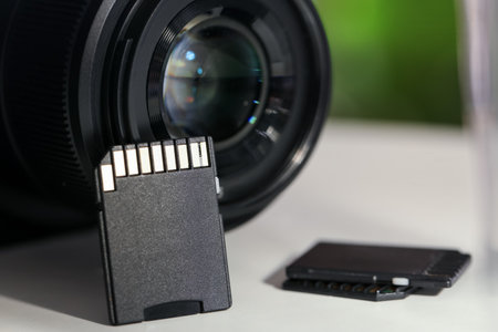 SD memory cards and photo camera on white table, closeupの写真素材