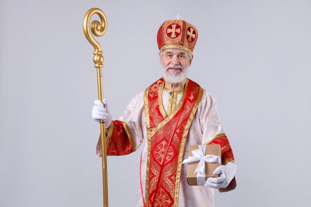 Saint Nicholas with gift on light gray backgroundの写真素材