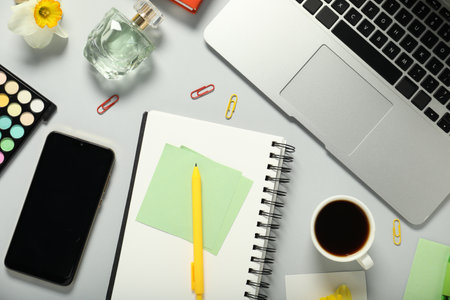 Flat lay composition with stationery, flower and coffee on light grey backgroundの写真素材