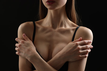 Woman with perfect skin on black background, closeupの写真素材