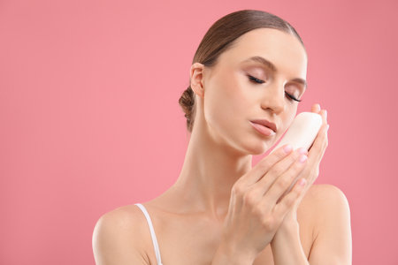 Beautiful woman with soap bar on pink background. Space for textの写真素材