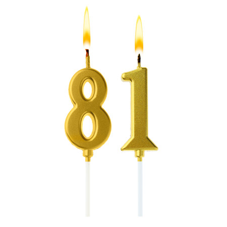 Burning golden cake candles composing number 81 on white background. Festive decoration for birthday or other special dateの写真素材