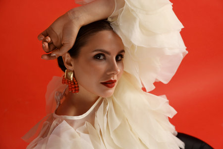 Young woman in stylish clothes on red backgroundの写真素材