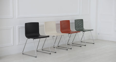 Colorful chairs near white wall in waiting room