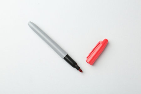 One red marker on light background, top view