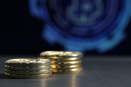 Cryptocurrency. Golden bitcoins on grey table, closeup. Space for text