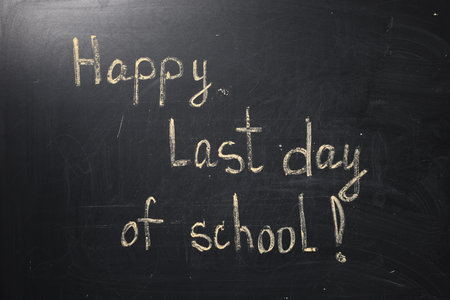 Phrase Happy Last Day of School with exclamation mark on blackboardの写真素材
