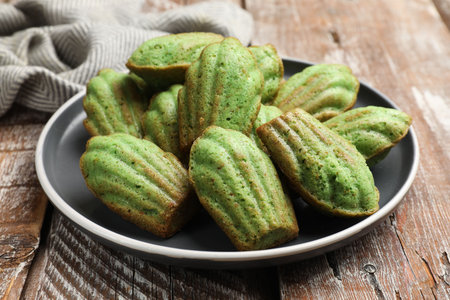 Tasty matcha madeleine cakes on wooden table, closeupの写真素材