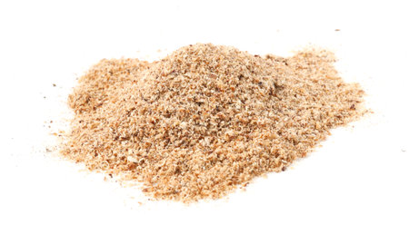 Pile of nutmeg powder isolated on whiteの写真素材
