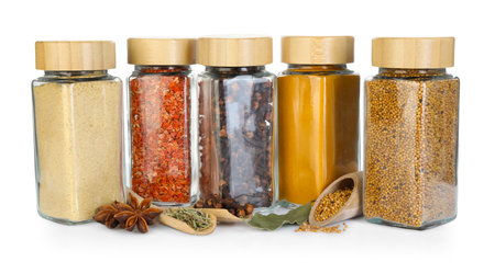 Many different aromatic spices in jars isolated on whiteの写真素材