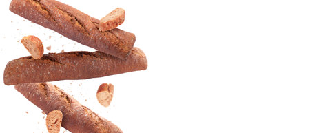 Fresh baguettes falling on white background. Banner design with space for textの写真素材