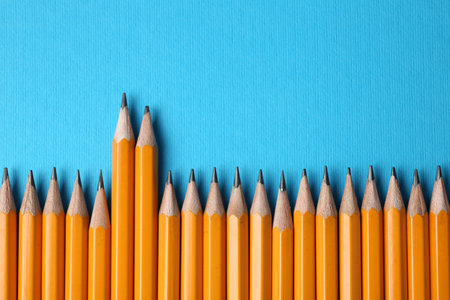 Sharp graphite pencils on light blue background, flat lay. Space for textの写真素材
