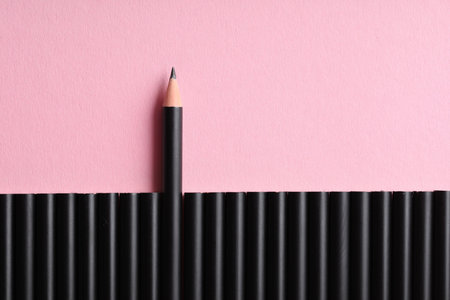 Many sharp graphite pencil on pink background, flat lay. Space for text