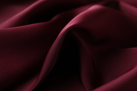 Crumpled burgundy silk fabric as background, closeup
